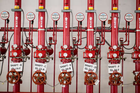 pipe system, red pipe system attached on wall buildingの写真素材