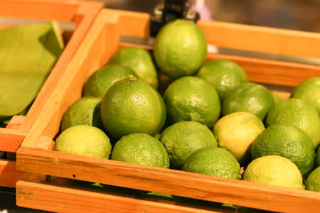 lime, green lime in wood box selling at the market, Thailandの写真素材