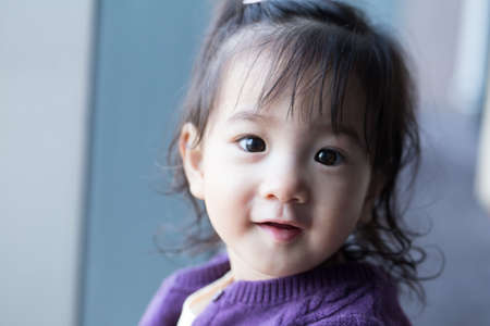 Asian kid, Portrait of one Thai cute young girl kid smiling at cameraの写真素材