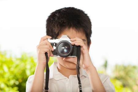 camera boy an Asian young boy learning retro film cameraの写真素材