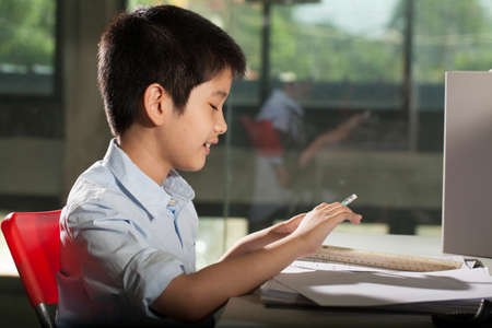 kid life an Asian boy activity studying on a lesson