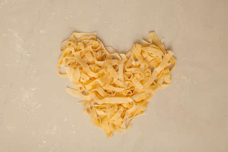 Fresh Pasta Raw fresh pasta tagliatelle on backgroundの写真素材