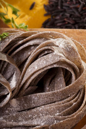 black pasta, close-up to uncook dried black pasta mix with black rice, Thailandの写真素材