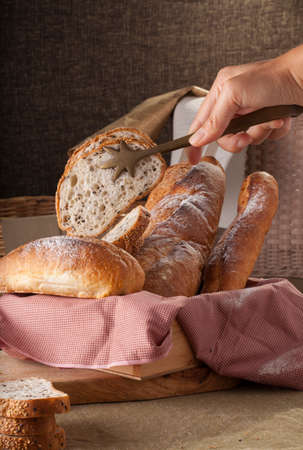Bread, a set of variation of breads on a wood chopping block with spikeの写真素材