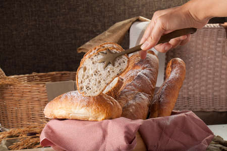 Bread, a set of variation of breads on a wood chopping block with spikeの写真素材