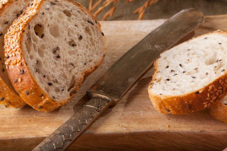 Bread, a set of variation of breads on a wood chopping block with knife