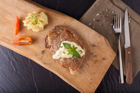 steak, a prepared piece of steak cut with blue cheese sauce on dining table decoratedの写真素材