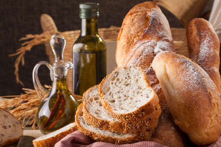 Bread, a set of variation of breads on a wood chopping block with knife
