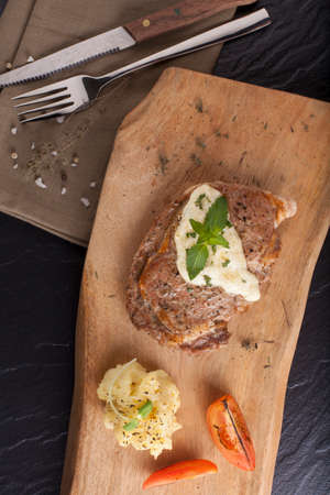 steak, a prepared piece of steak cut with blue cheese sauce on dining table decoratedの写真素材