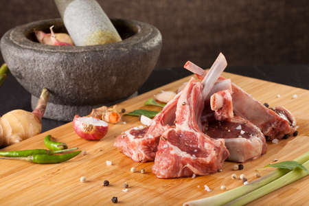 Thai Rack of lamb, Raw rack of lamb cut in pieces decorate and seasoning with Thai herbの写真素材