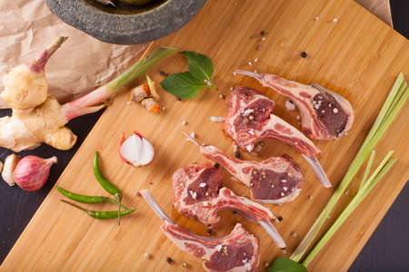 Thai Rack of lamb, Raw rack of lamb cut in pieces decorate and seasoning with Thai herbの写真素材