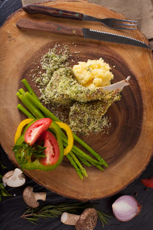 Rack of lamb mint steak, Rack of lamb steak cut in pieces seasoning with crusted mint vegetable and herbs and red wine serve on chopping wood blockの写真素材