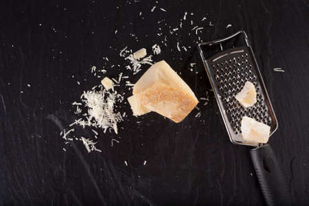 grated cheese, grated parmesan cheese with a graterの写真素材