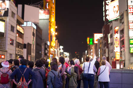 OSAKA, JAPAN - NOVEMBER 5, 2015 : Osaka at night, Showing tourism in Osaka attraction at night acting fun for photo shoot, Osaka, Japanのeditorial素材