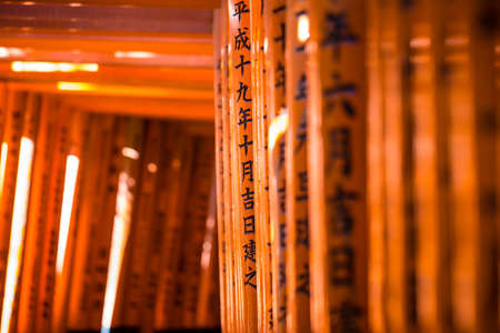 Fushimi Inari, The unique Japanese font written on red color pole or "Torii" at Fushimi Inari Taisha in Kyoto, Japanのeditorial素材