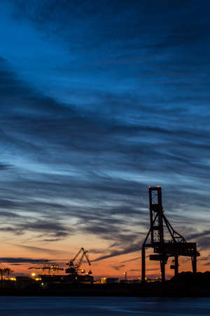 twilight sky, colourful twilight sky over port town city light with construction buildingの写真素材