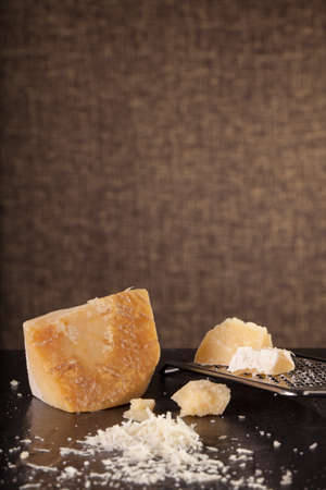 grated cheese, grated parmesan cheese with a grater and a jar and bottle of olive  oilの写真素材
