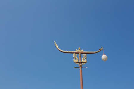 Thai style street golden light pole showing pattern of art with lanternの写真素材