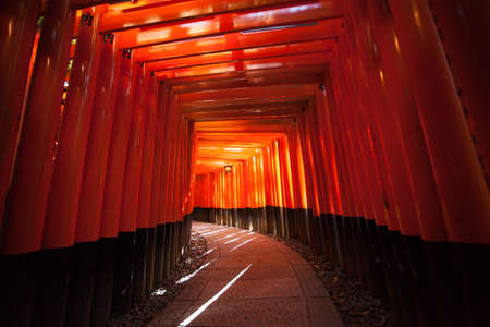Red Torii pole tunnel at Fushimi Inari Shrine, each pole written names of donator , Kyoto Japanのeditorial素材