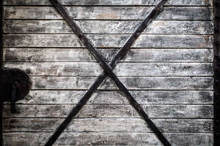 Vintage wood train door showing texture with iron decorateの写真素材