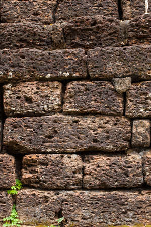 Historical old stone wall with moss and dust attached by its life time.の写真素材