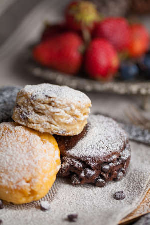Mix flavour of scone biscuit decorate with chocolate ship and fresh strawberry and blueberryの写真素材