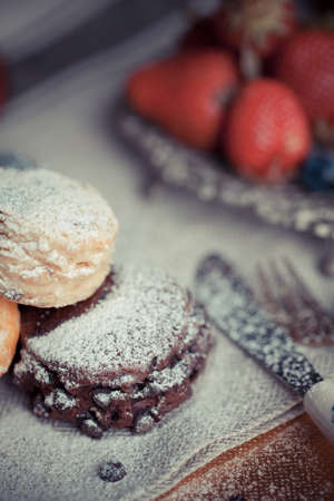 Mix flavour of scone biscuit decorate with chocolate ship and fresh strawberry and blueberryの写真素材