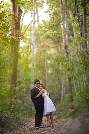 A couple in formal dress black suit and white dress romance in the pine forest before wedding, Thailandの写真素材