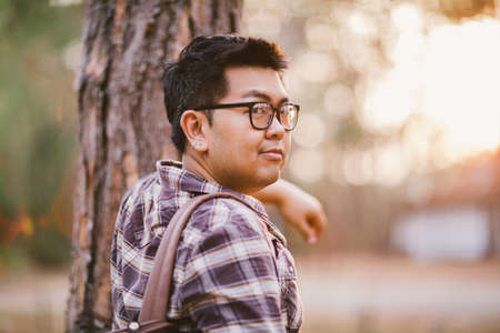 A male traveller with his sunglasses and backpack in the pine forest, Thailandの写真素材