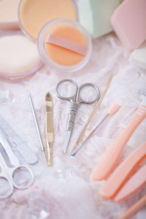 Cosmetic accessories mixed with hair salon equipment in cute candy color.