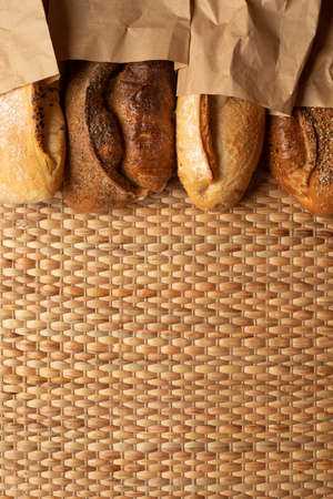 Various kind of bread put together on weave grass background with copy space.の写真素材