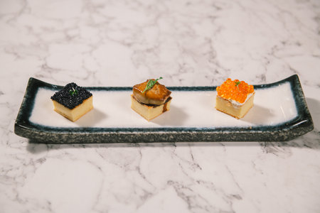 Japanese sweet egg topped with salmon roe, foie gras and caviar on a plate.の写真素材