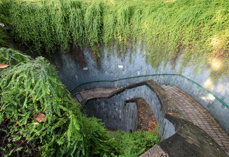 Spiral staircase of underground crossing in tunnel at Fort Canning Park, Singapore.のeditorial素材