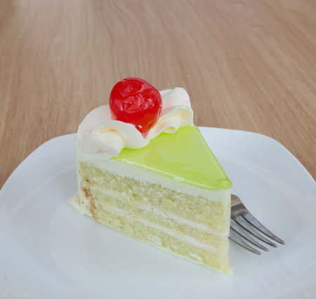 vanilla cake slice with fresh cherryの写真素材