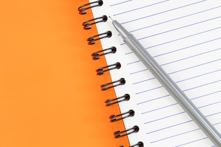 notebook spiral bound and pen on white backgroundの写真素材
