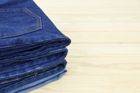 Blue jeans on wooden backgroundの写真素材