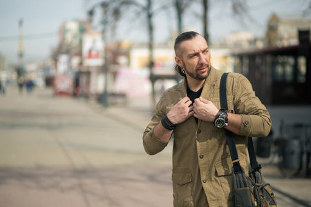 a young businessman is walking with a bag on the street.の写真素材