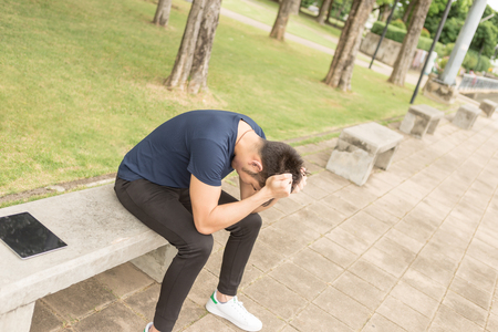 Business man working failing serious with tablet in the park.の写真素材
