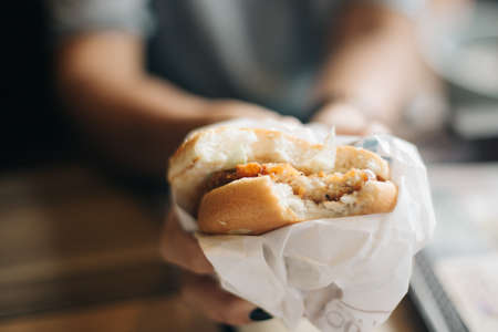 Close up of female hands Holding delicious Chicken burgerの写真素材