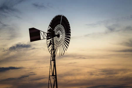 View to Windmill against colorful sunsetの写真素材