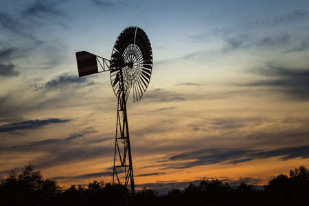 View to Windmill against colorful sunsetの写真素材