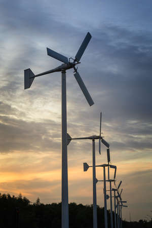 Wind generators turbines on sunset summer landscapeの写真素材