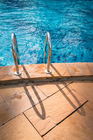 Swimming pool with stair at hotel close upの写真素材
