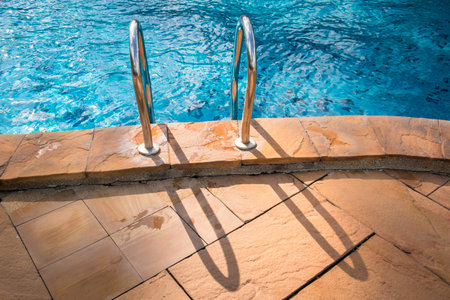 Swimming pool with stair at hotel close upの写真素材