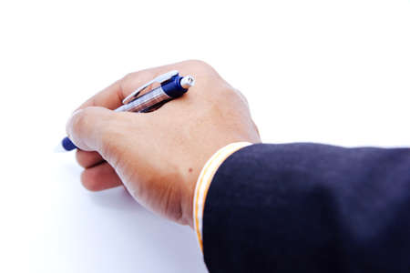 Blue pen in hand ready to sign on white isolatedの写真素材