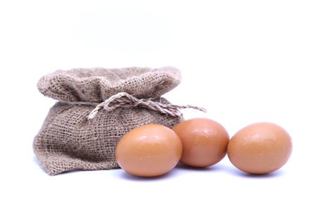 Brown eggs  and brown sack with white isolated