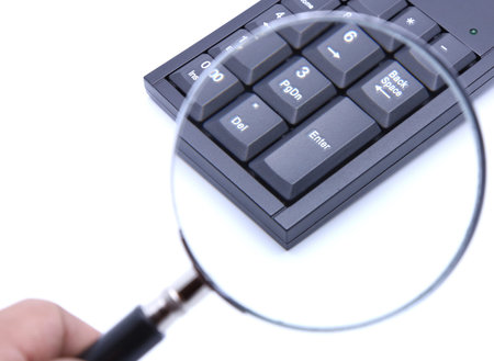 Magnifier to Enter key of calculator keyboard on white isolated