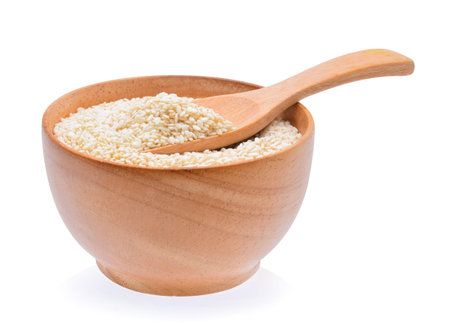 white sesame in wooden bowl on white backgroundの写真素材