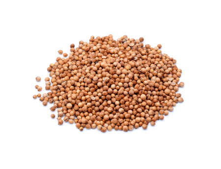 Pile of coriander seeds isolated on white backgroundの写真素材