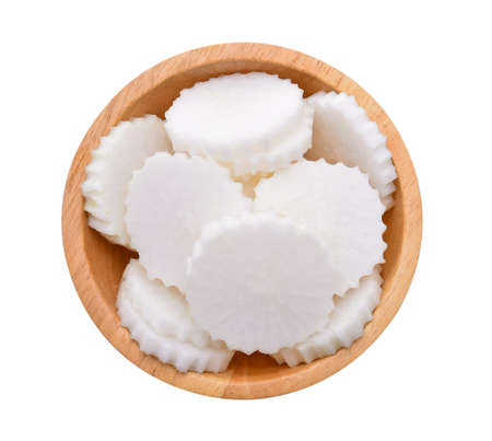 Sliced radish in wooden bowl isolated on white background,Top viewの写真素材